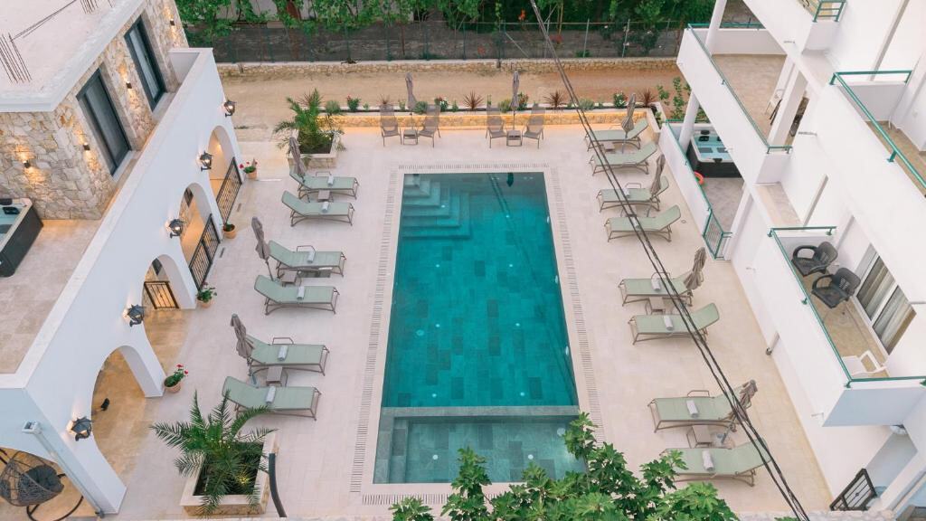 Outdoor infinity pool with sun loungers at B&B Lovac Pool & Spa in Ulcinj